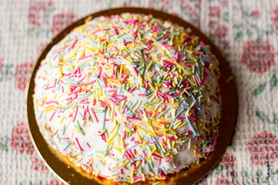 A festive dome-shaped celebration cake covered in colorful sprinkles