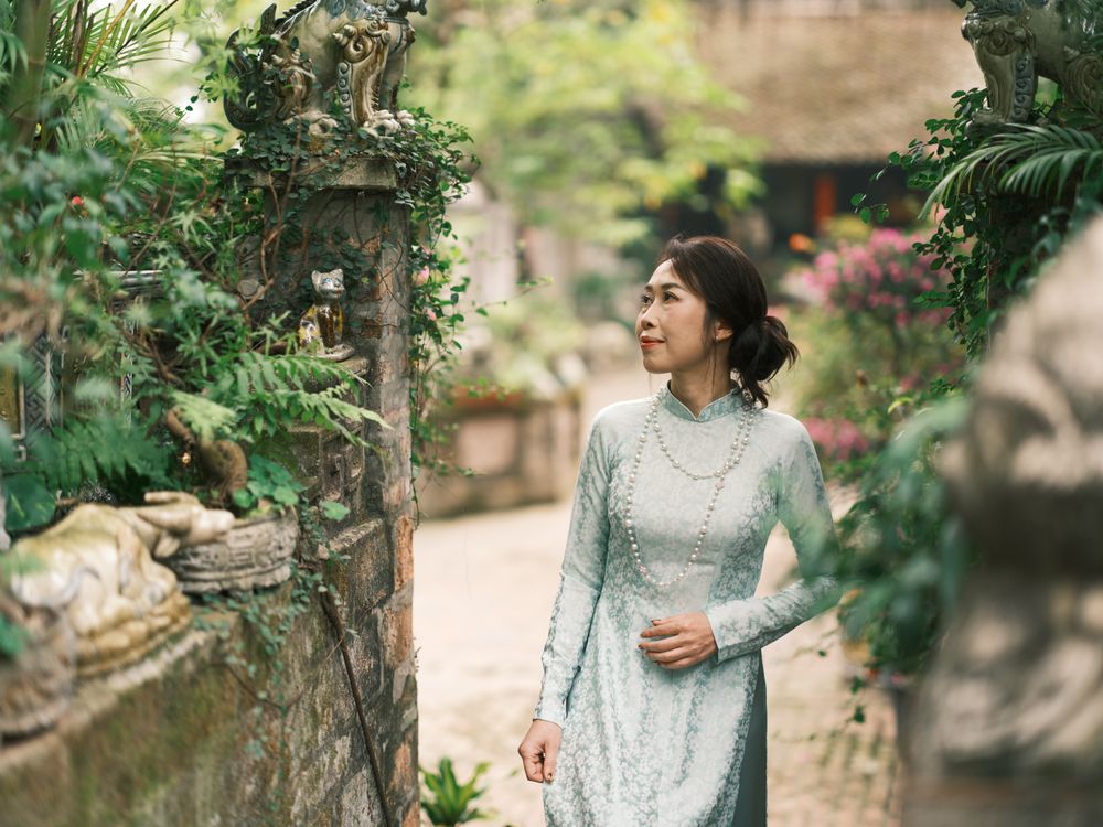 Elegant Vietnamese Woman Strolling Outdoors in Ao Dai · Free Stock Photo