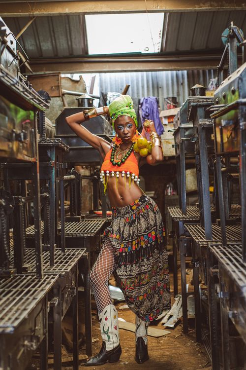 Free Colorful portrait of a woman in traditional attire, set in an eclectic Nairobi setting. Stock Photo
