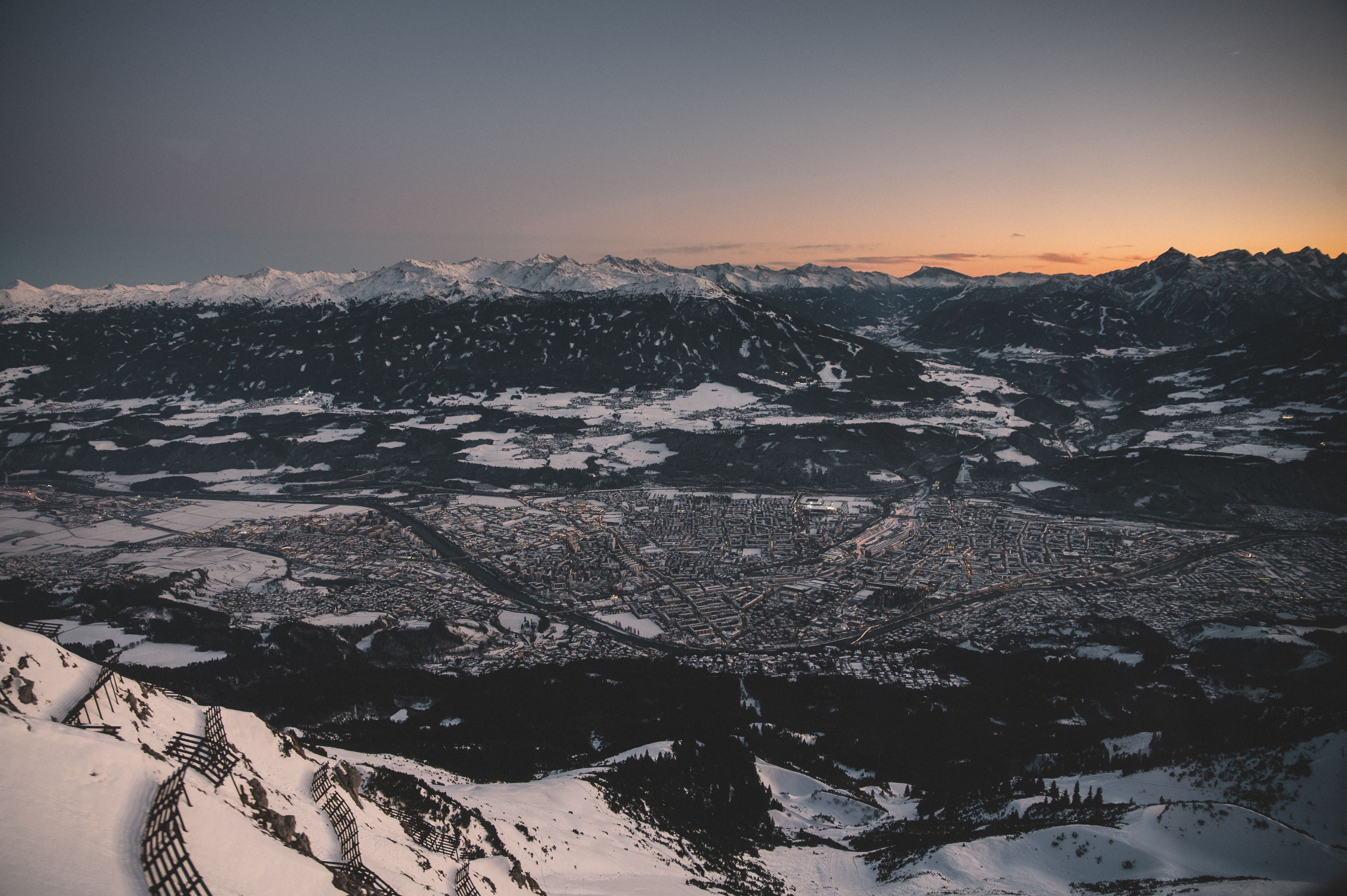 Innsbruck at dusk, ringed by the snow-covered Alps
