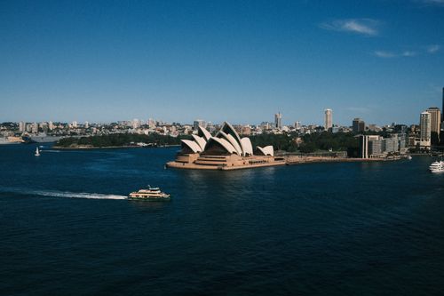 Free Aerial view of the iconic Sydney Opera House and harbor with ferry and cityscape. Stock Photo