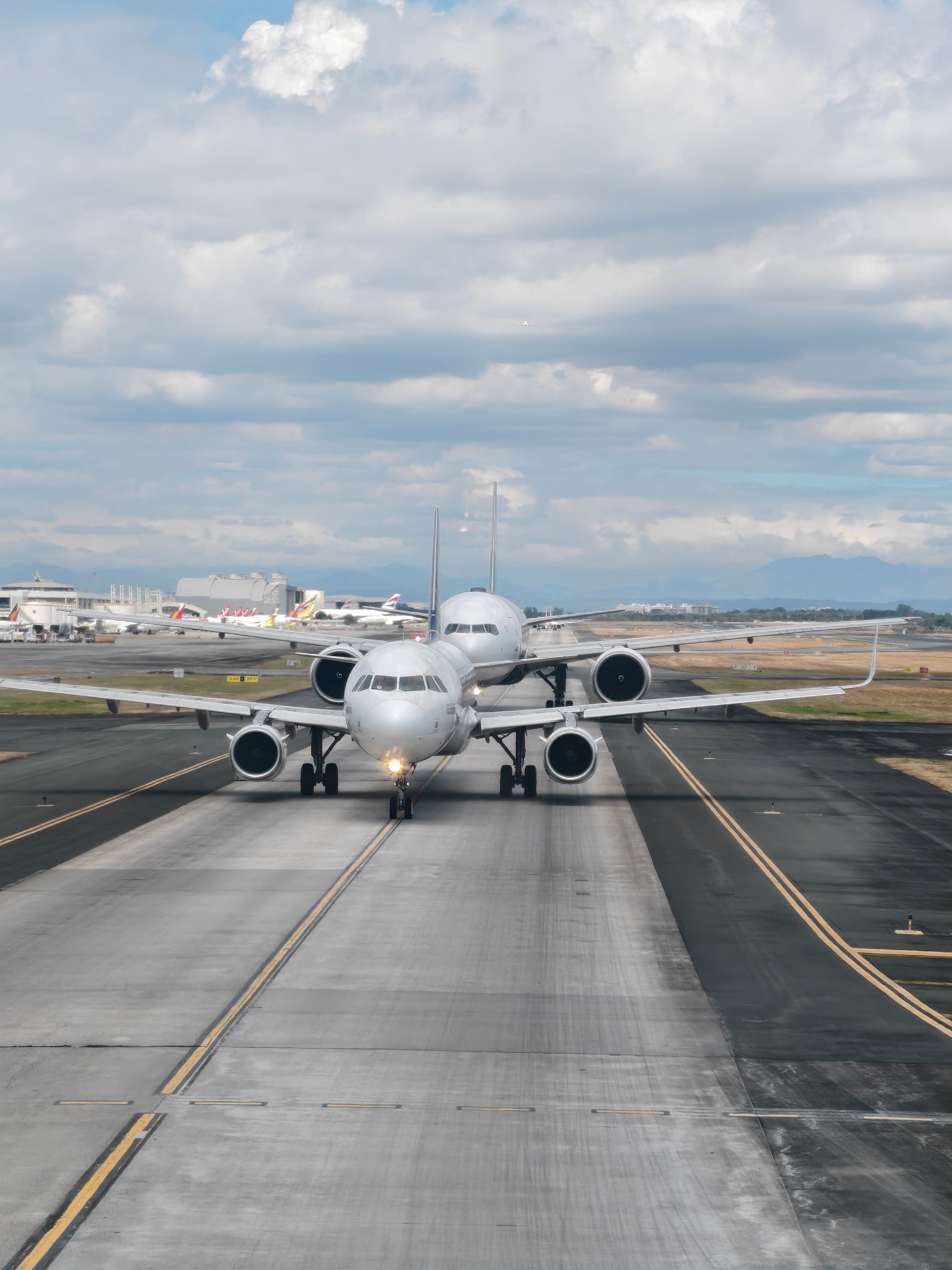 A lineup of airplanes on the runway at Ninoy Aquino International Airport in Pasay City, Philippines.