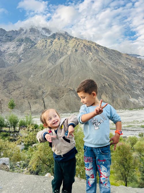 Free Joyful children having fun in a mountainous landscape, showcasing a vibrant and carefree moment. Stock Photo