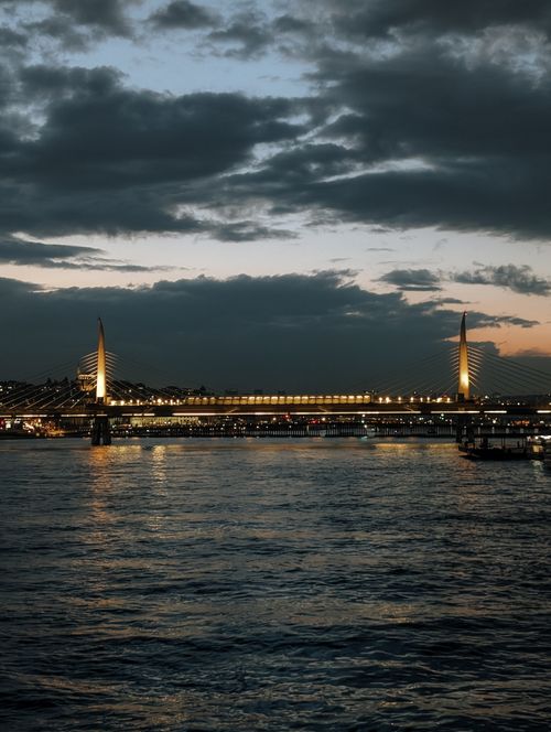 Free Stunning twilight scene of Golden Horn Metro Bridge, reflecting on the waters of İstanbul. Stock Photo