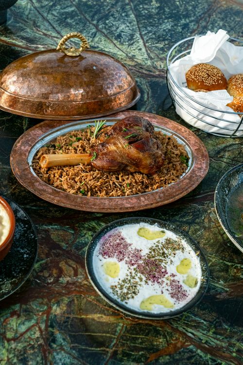 Free Traditional Middle Eastern dish of lamb with rice beautifully plated outdoors. Stock Photo