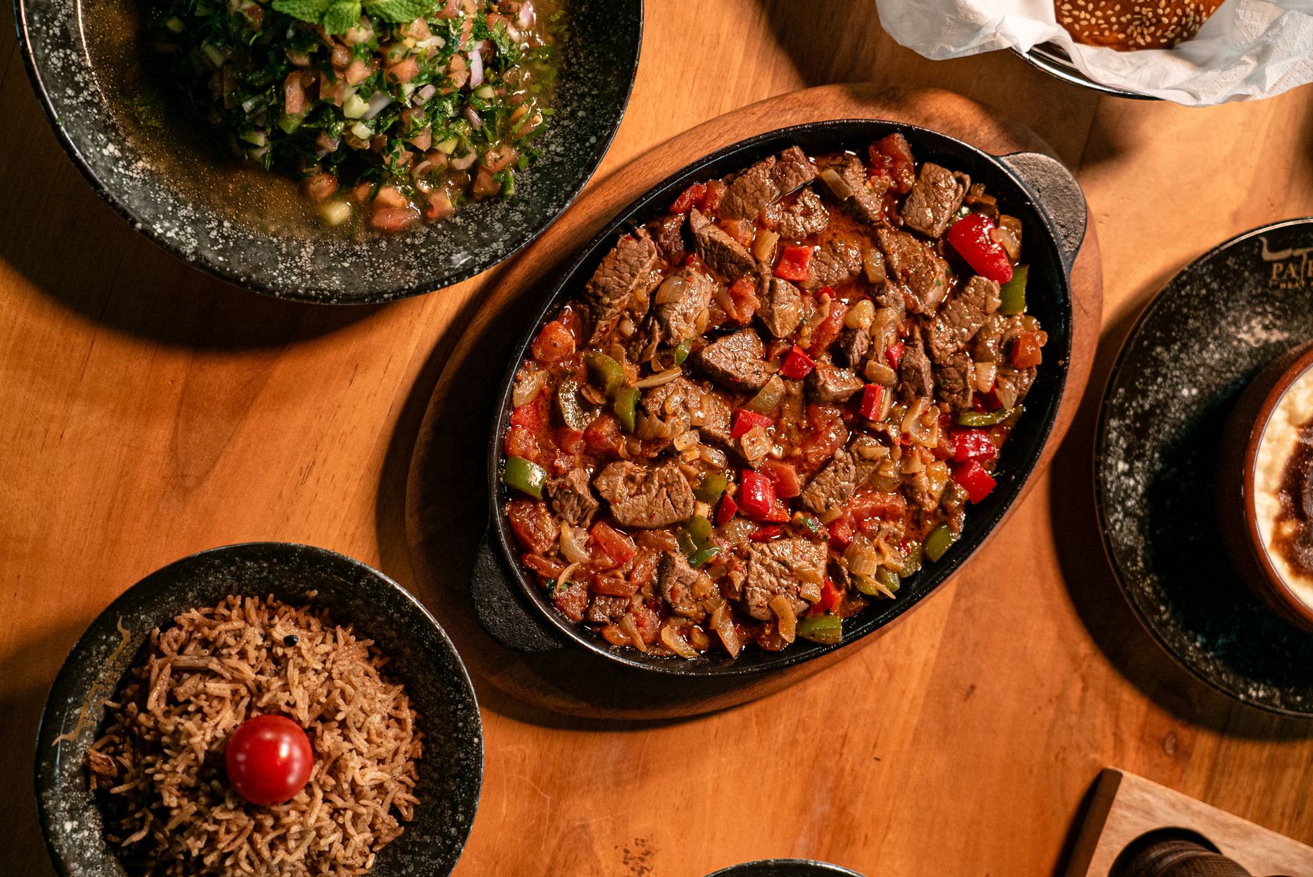 A vibrant dish of West African Jollof rice served with grilled chicken and plantains
