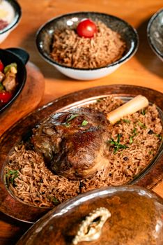 Succulent lamb shank served on a bed of fragrant spiced rice. Perfect for gourmet dining.