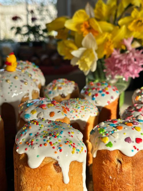 Free Colorful sprinkles on Easter bread with daffodils in bright sunlight. Stock Photo