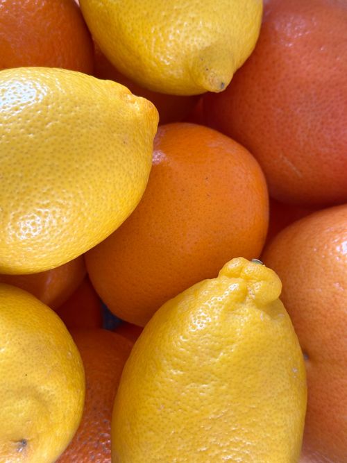 Free Vibrant close-up of fresh lemons and oranges showcasing rich textures and colors. Stock Photo