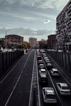 View of a bustling city street with heavy traffic during sunset, showcasing urban architecture.