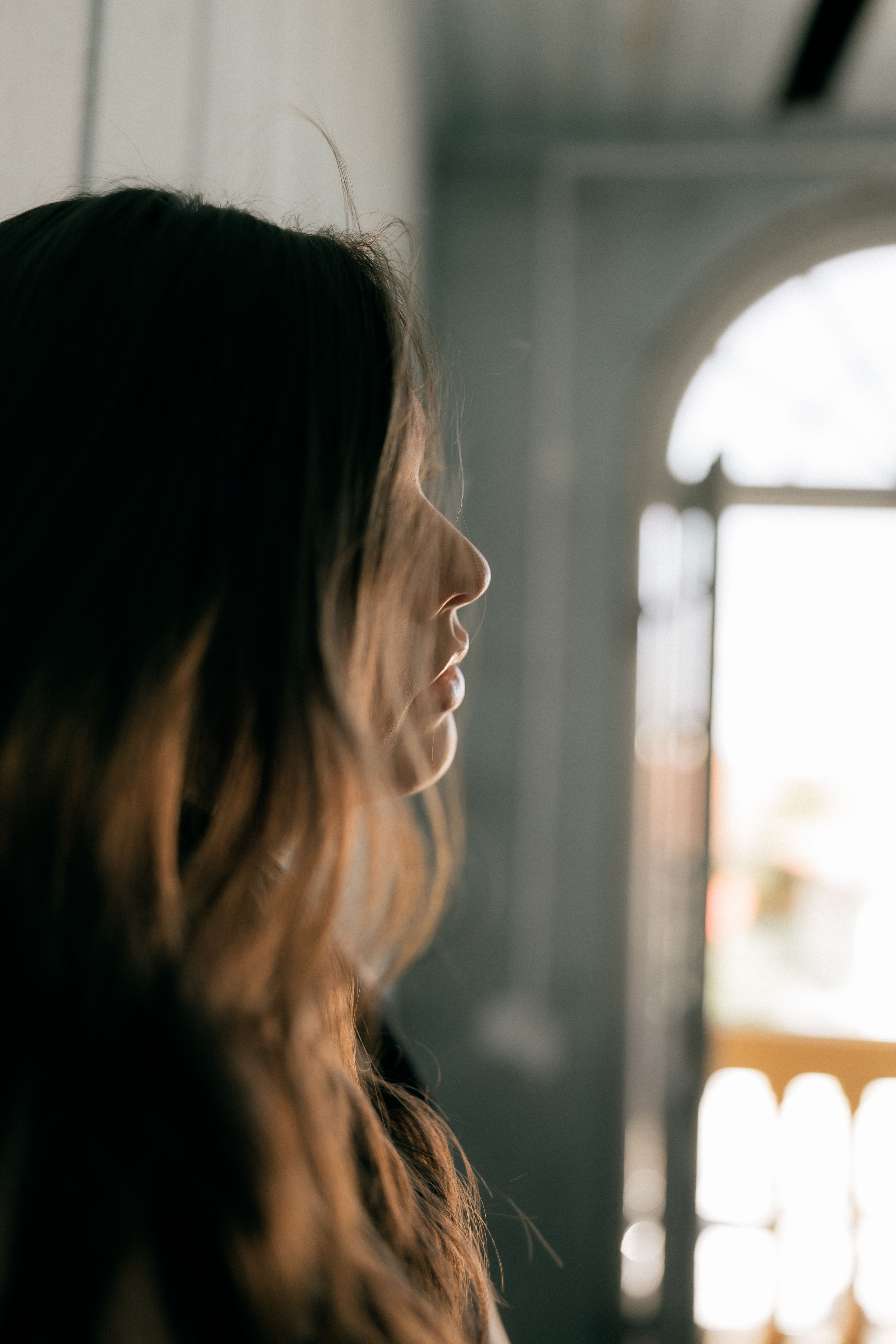 Woman in White Shirt Looking Out the Window · Free Stock Photo