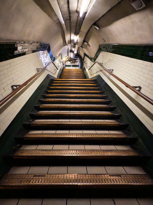 Free View of a historic narrow underground staircase leading up in a tunnel. Stock Photo
