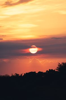 Captivating sunset scene with a vivid sky over silhouetted trees, perfect for serene and warm imagery.