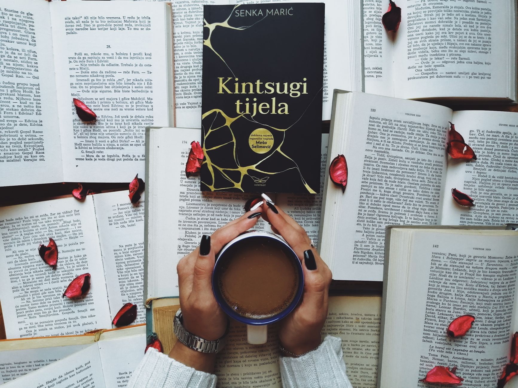 A serene scene featuring a book, cup of coffee, and scattered rose petals, perfect for relaxation themes.