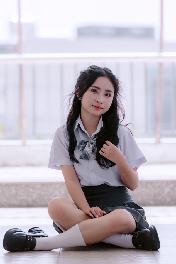 Young Woman in School Uniform Holding a Book · Free Stock Photo