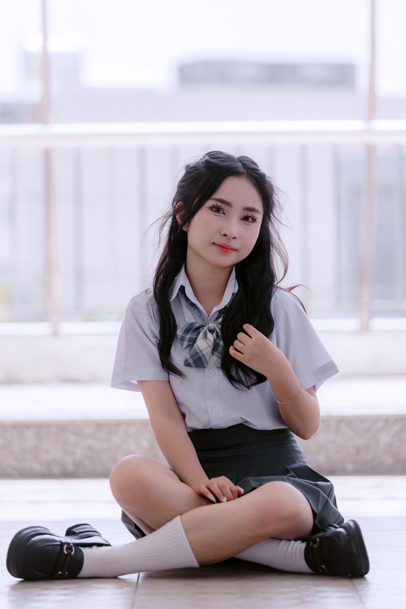 Young Woman in School Uniform Holding a Book · Free Stock Photo