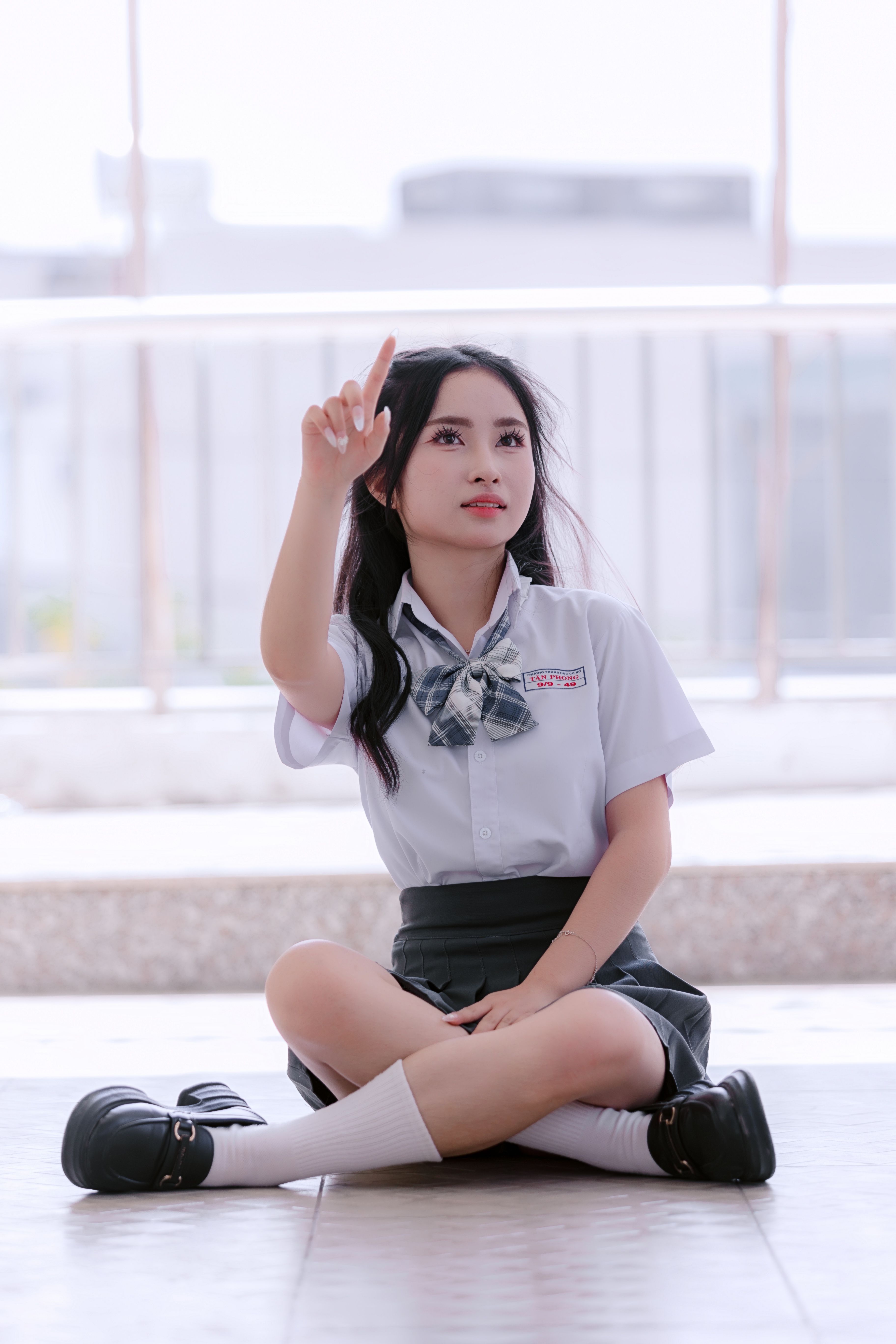 Young Woman in School Uniform Holding a Book · Free Stock Photo