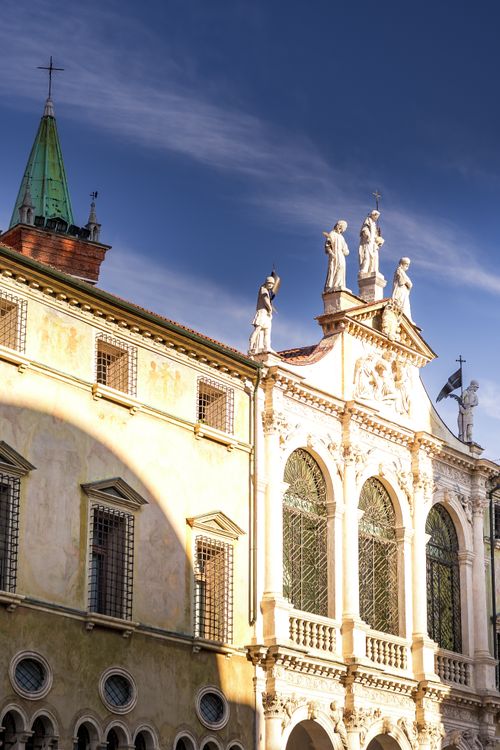Free Historic Venetian architecture with statues illuminated by sunlight against a clear blue sky. Stock Photo
