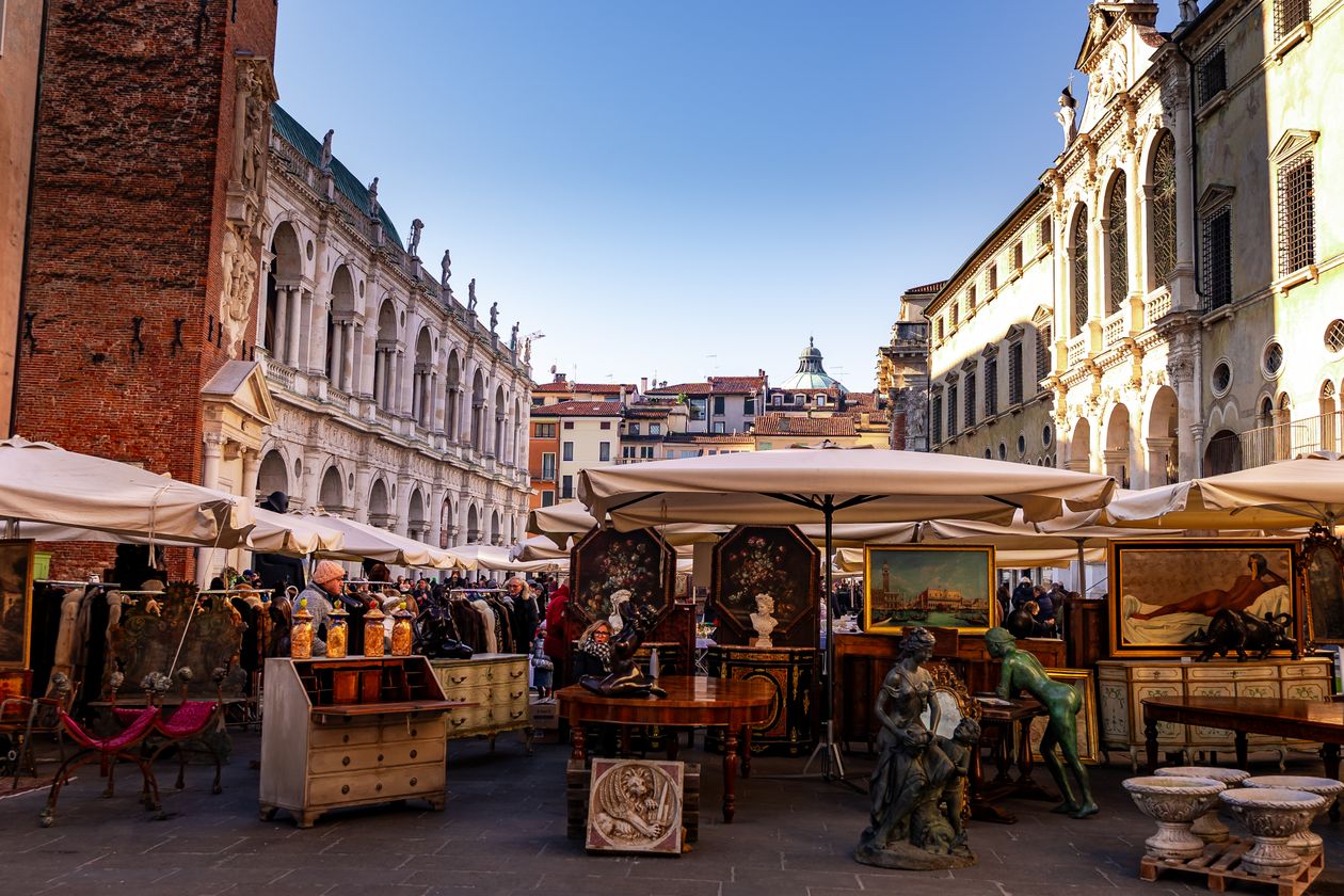 Outdoor antique market with vintage furniture and collectibles on display