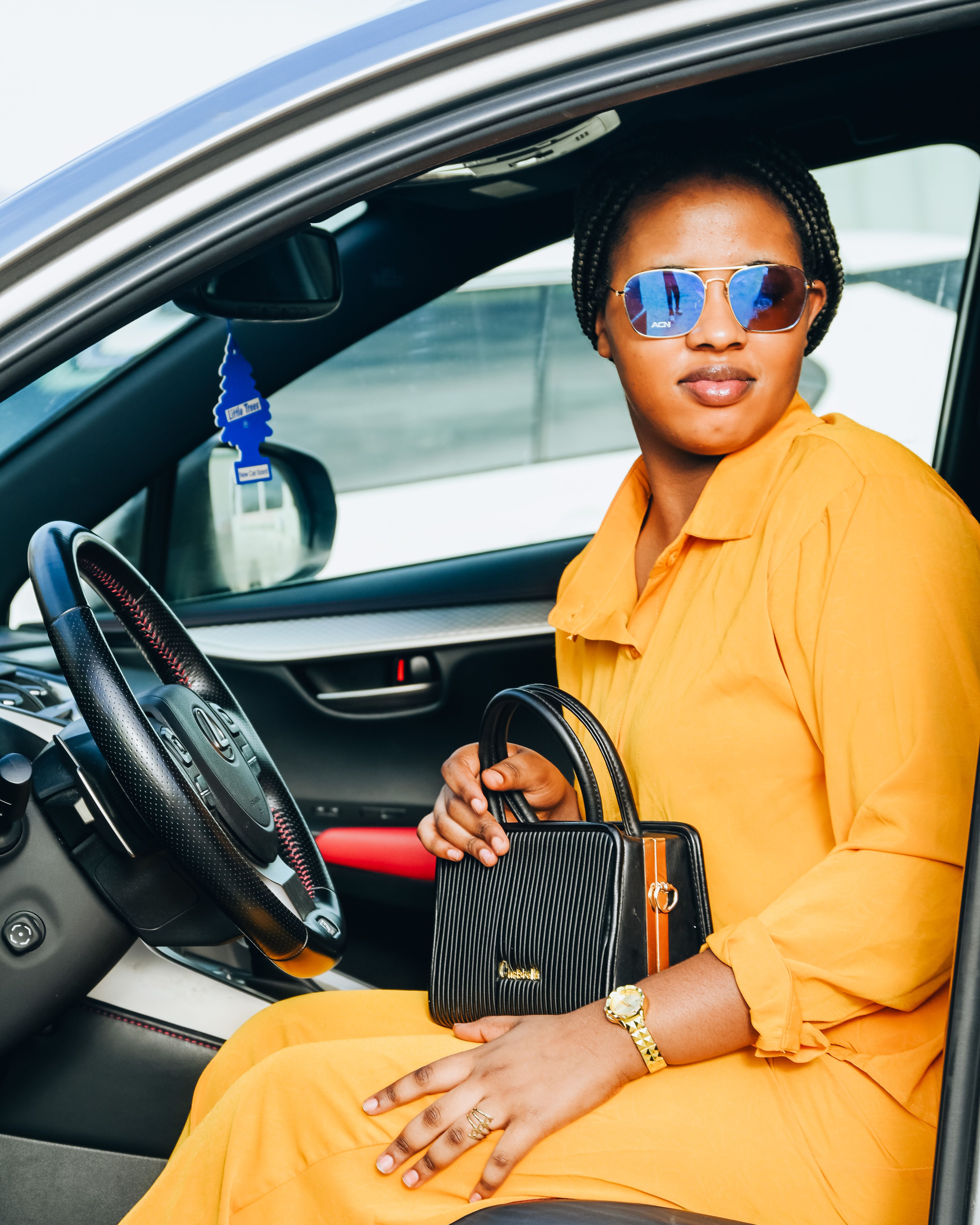 Stylish Woman in Yellow Dress Sits in Car · Free Stock Photo