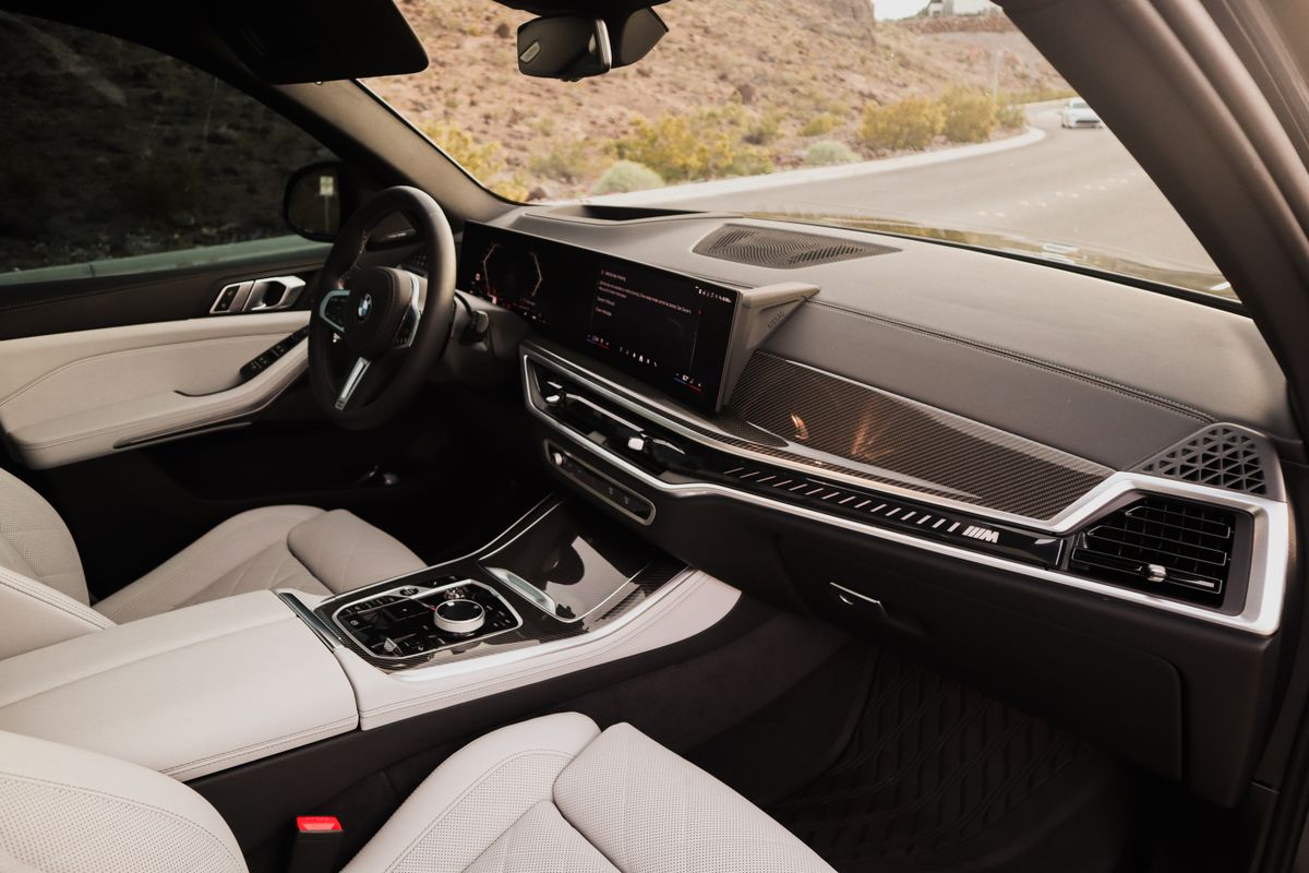 Luxury vehicle interior with premium dashboard, steering wheel, and automotive controls