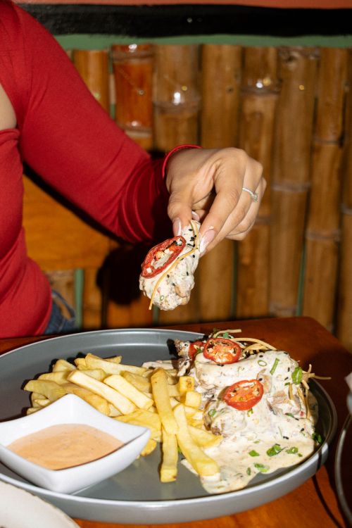 Free Enjoy flavorful chicken wraps with fresh ingredients and crispy fries, perfect for a delightful meal. Stock Photo
