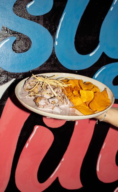 A glass 9x13 baking dish of sliced candied yams glazed in a glossy, thickened brown sugar and butter syrup, with a light dusting of cinnamon on top.