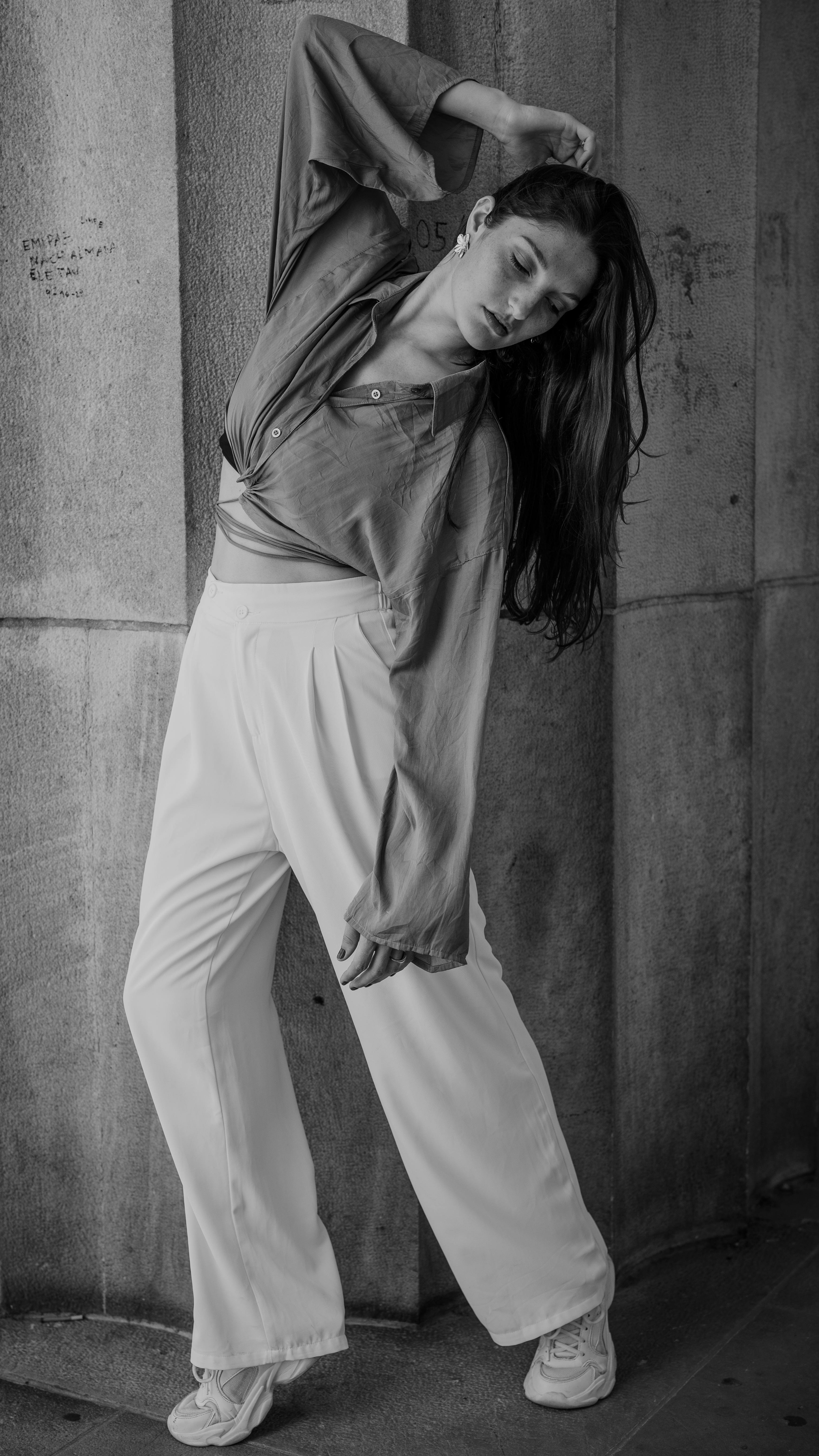 Graceful dancer posing in a monochrome portrait, showcasing elegance and poise.