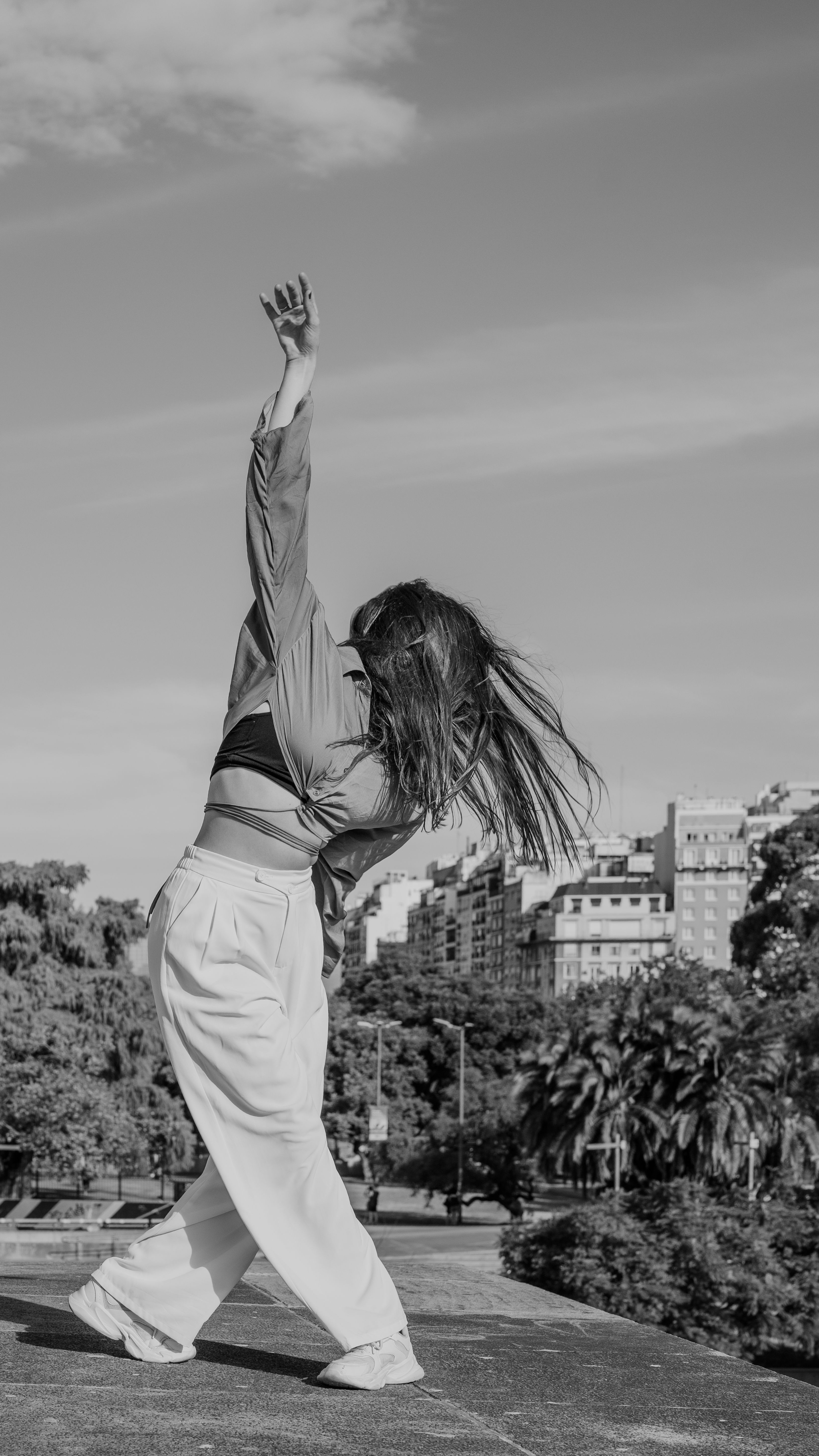 Woman Dancing Freely in Urban Park Setting · Free Stock Photo