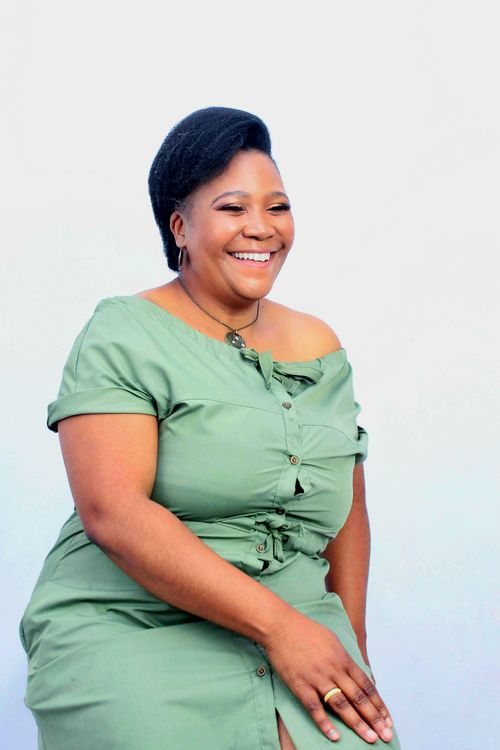 Smiling African Woman in Casual Green Dress · Free Stock Photo