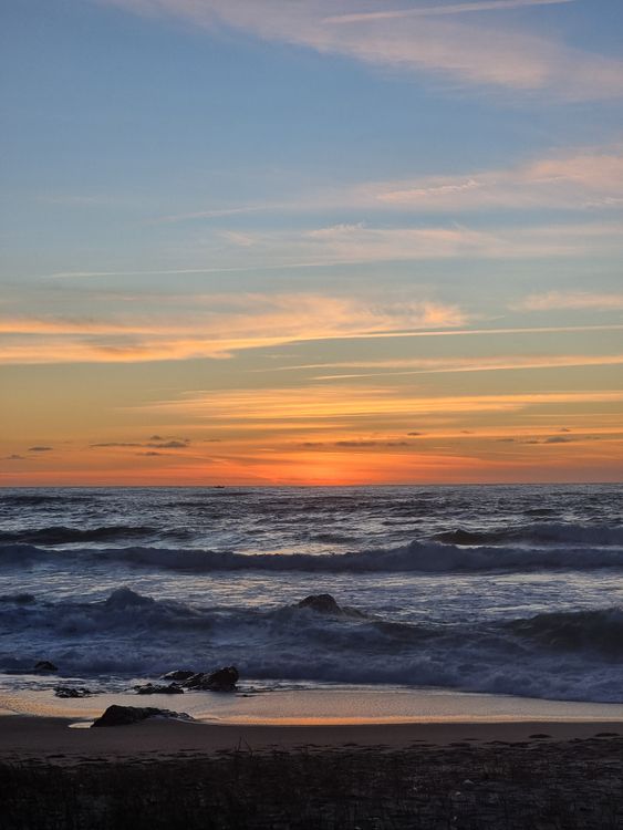 Stunning Sunset Over Ocean Waves at Beach · Free Stock Photo
