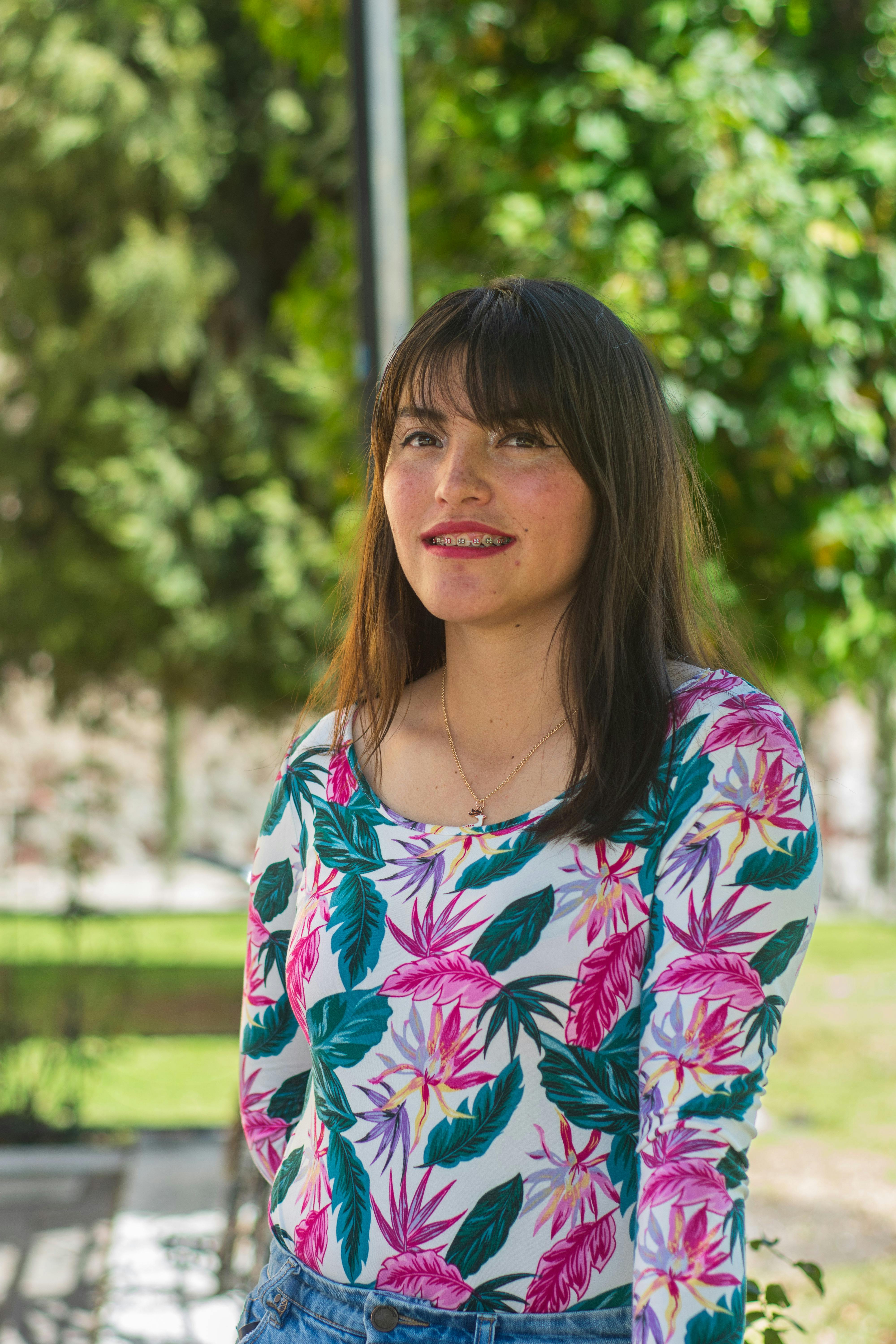 Portrait of a young woman with freckles smiling outdoors in Lerma, Mexico.