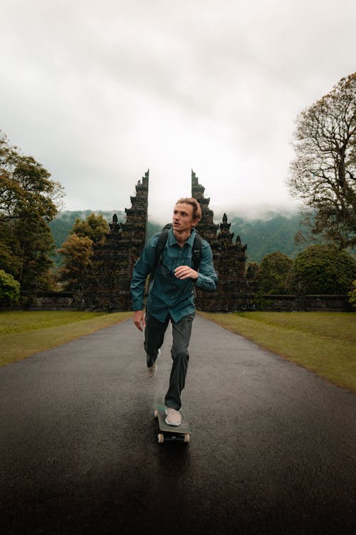 Man in Blue Long Sleeve Riding Skateboard