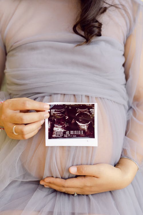 Free Pregnant Woman Holding Black and White Card Stock Photo
