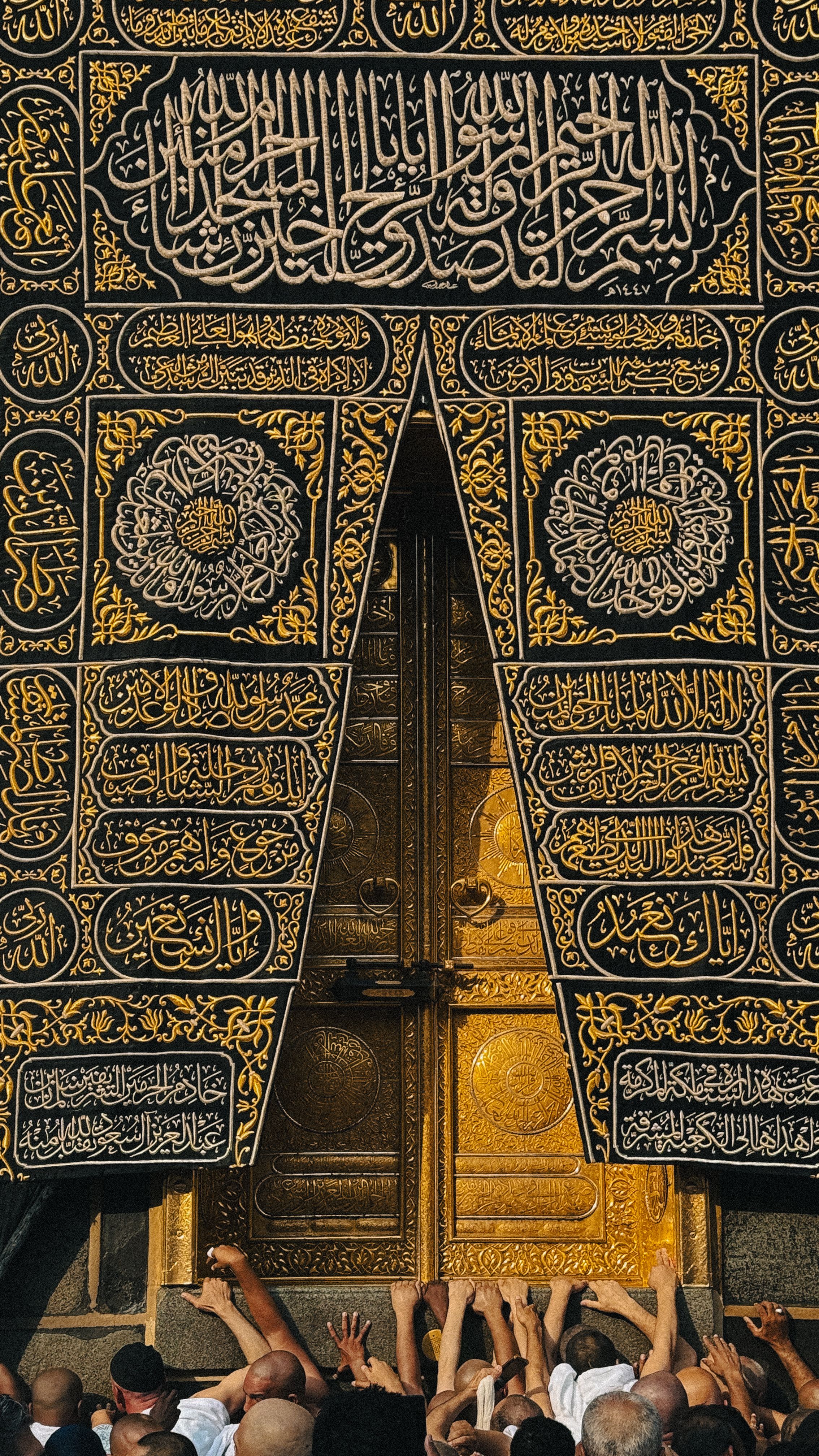 The golden doors of the Kaaba surrounded by Muslim pilgrims reaching out in reverence.