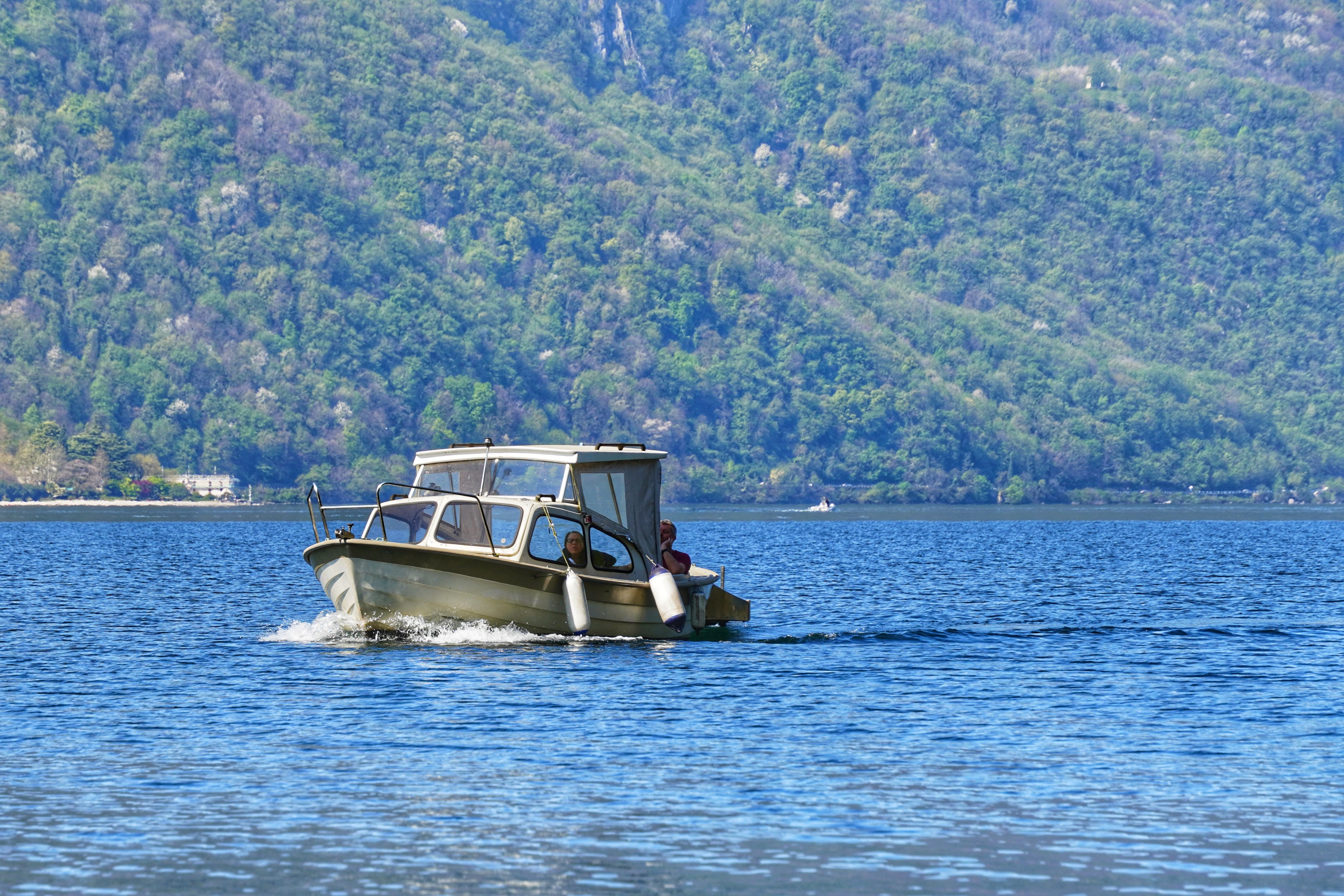 Scenic Boat Ride on Mountain Lake in Summer · Free Stock Photo