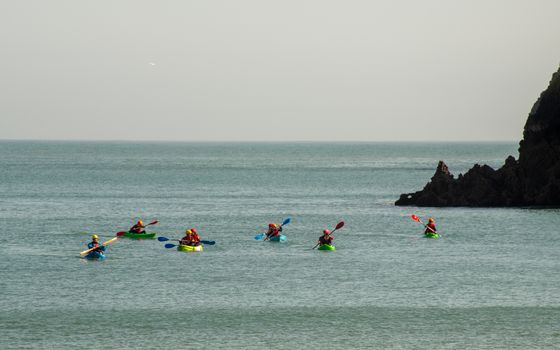 Enjoy a vibrant kayaking experience along the picturesque coastline of Wales, United Kingdom.