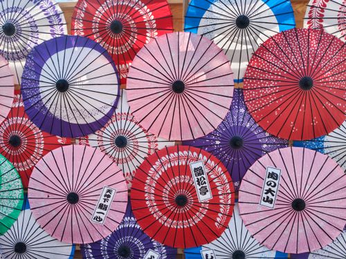 Free A vibrant collection of traditional Japanese paper umbrellas in various colors and patterns. Stock Photo
