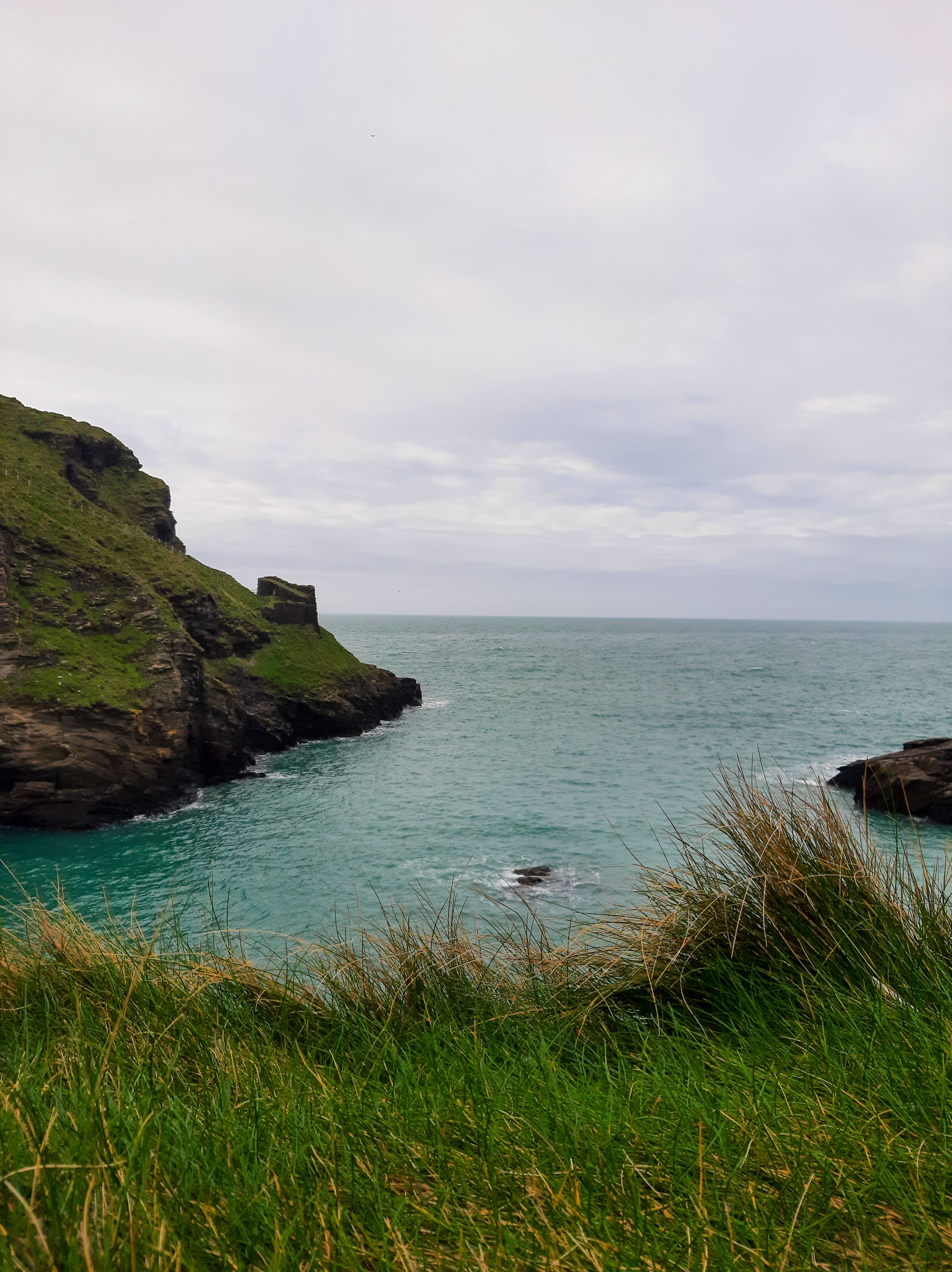 Scenic Coastal View with Rocky Cliffs and Greenery · Free Stock Photo
