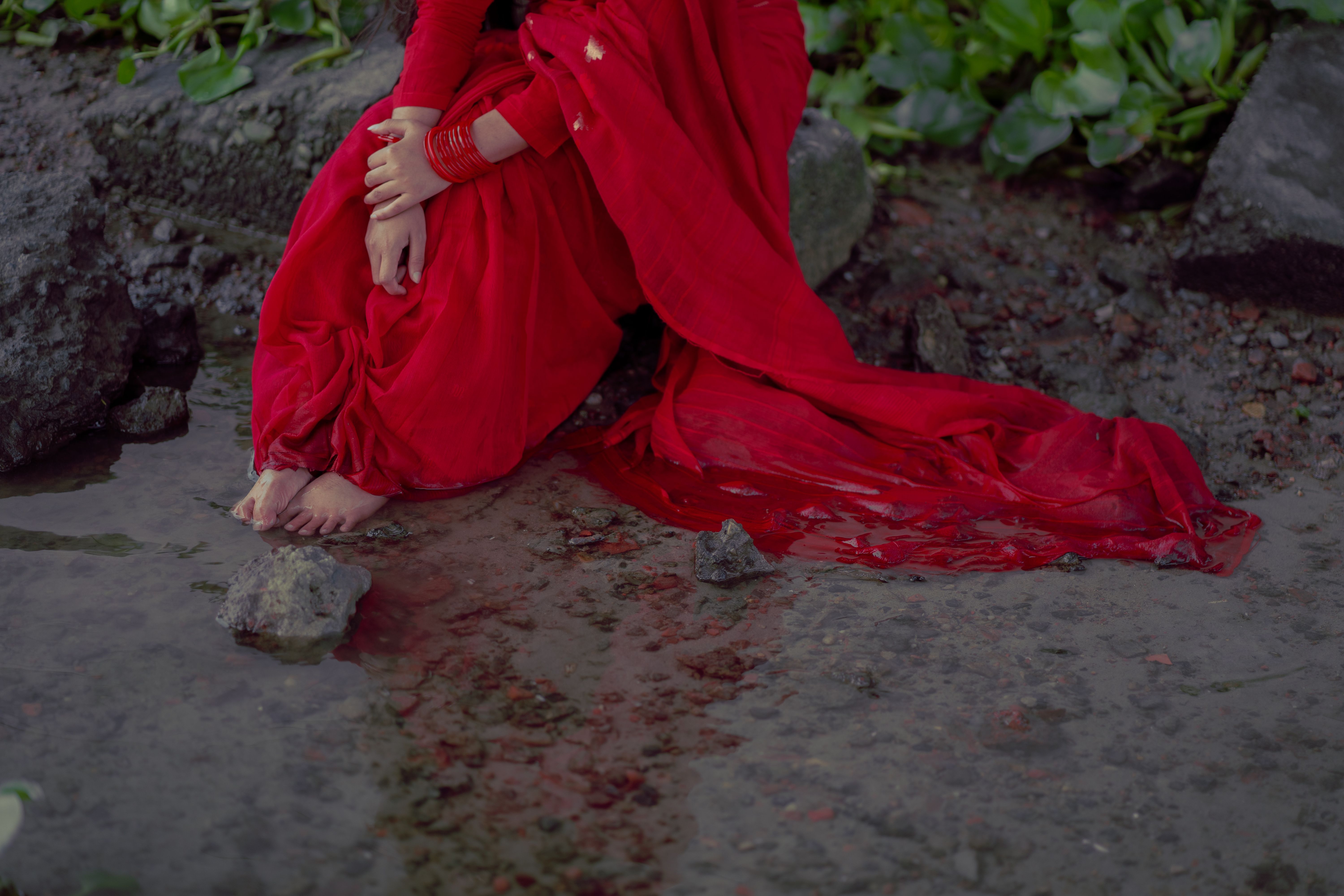 Woman in Red Dress Sitting by Water's Edge · Free Stock Photo