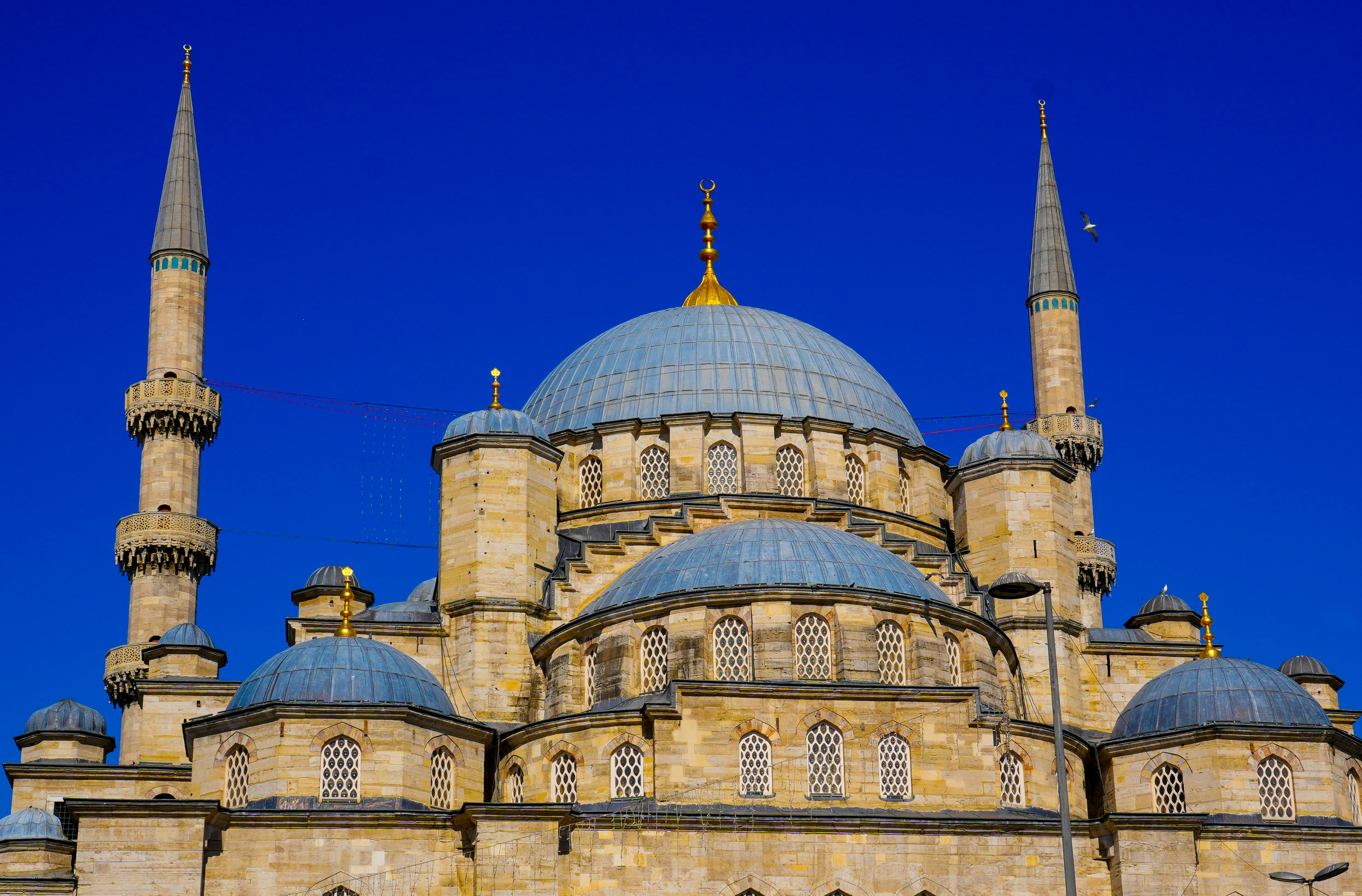 Blue Mosque at twilight with six minarets silhouetted against purple sky, domes cascading down, Istanbul's Sultanahmet Square