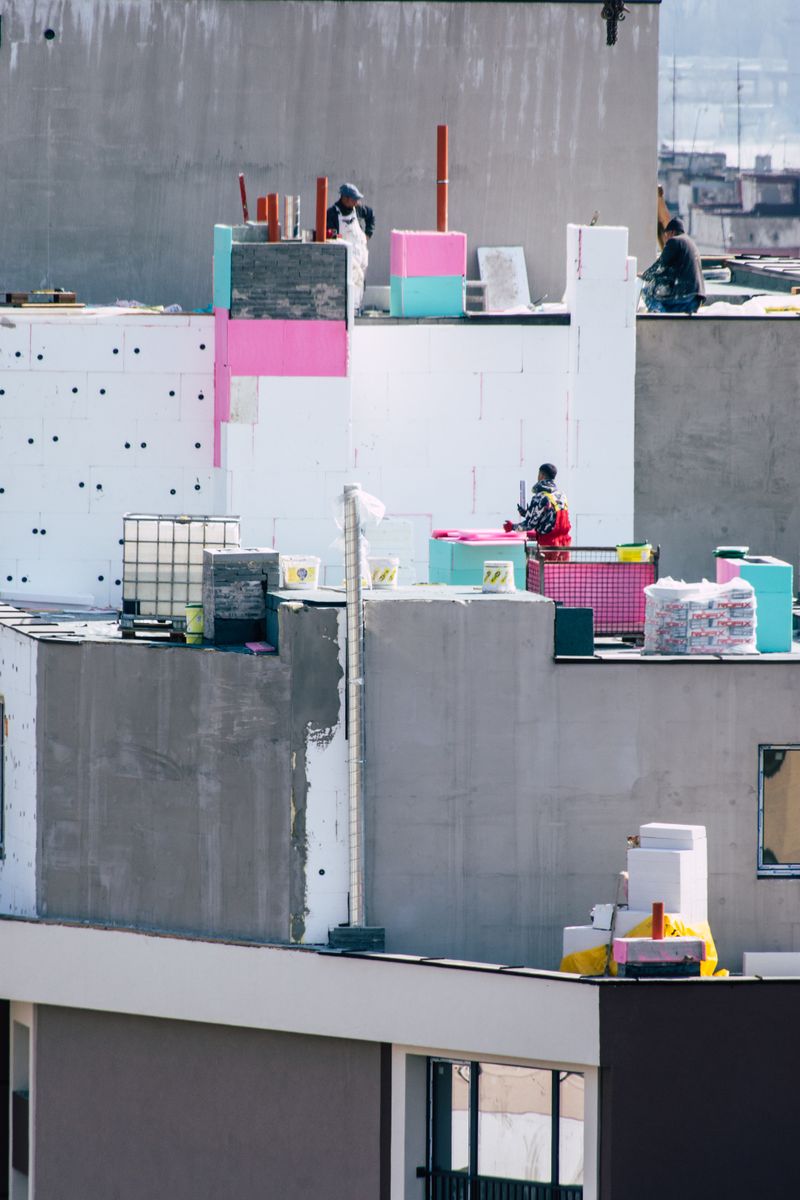 Workers insulating a rooftop