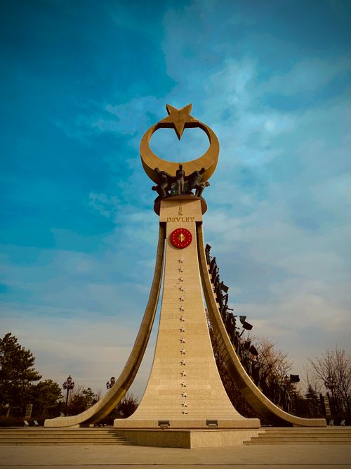 Free Striking monument in Ankara with crescent and star sculpture under a vivid blue sky. Stock Photo