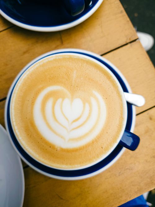 Free Beautiful overhead view of a latte with heart latte art in a Budapest cafe. Stock Photo
