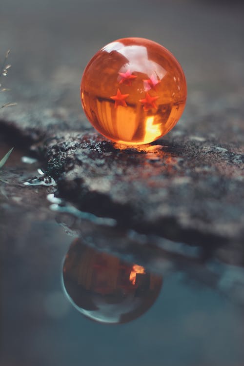 Orange Glass Bottle on Black and White Surface