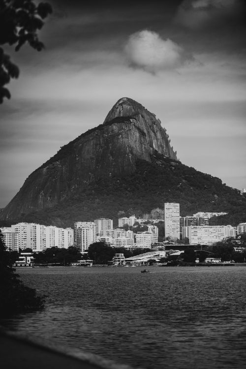 Free Black and white photo capturing the iconic Sugarloaf Mountain with Rio de Janeiro skyline in the foreground. Stock Photo