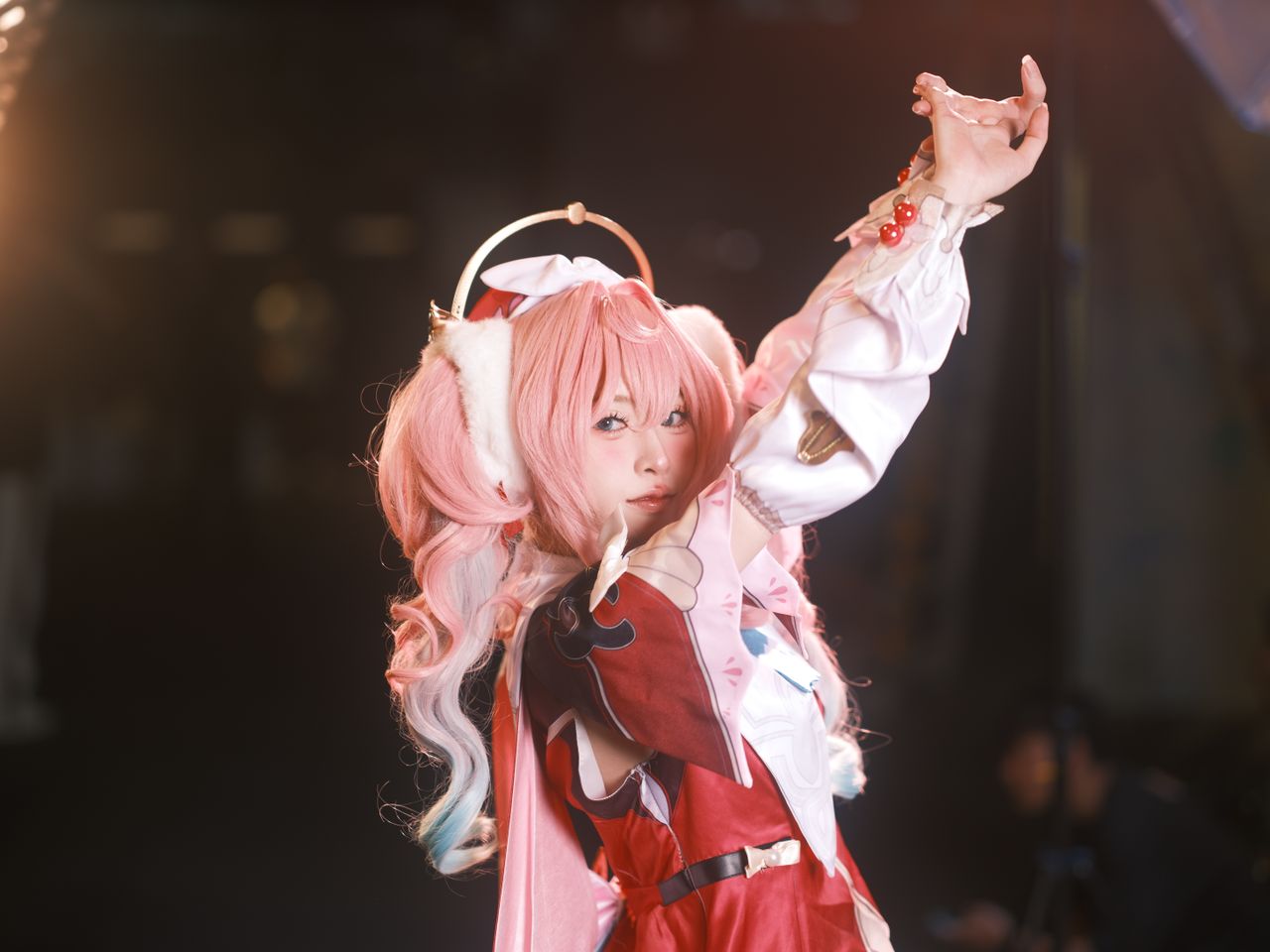 stylish cosplay performer with pink hair striking a pose capturing the