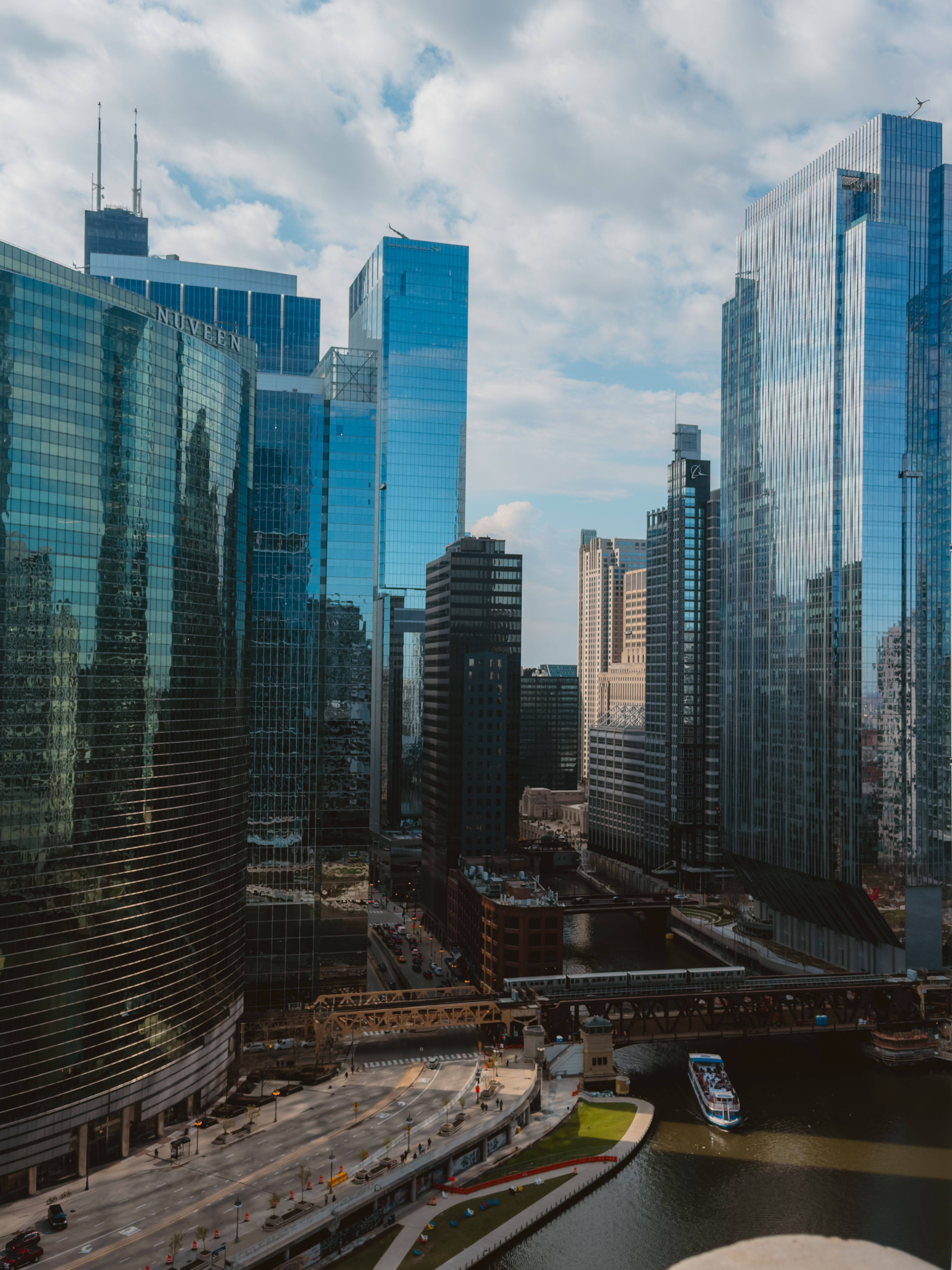 Aerial view of Chicago's skyline showcasing modern skyscrapers along the Chicago River on a summer day.