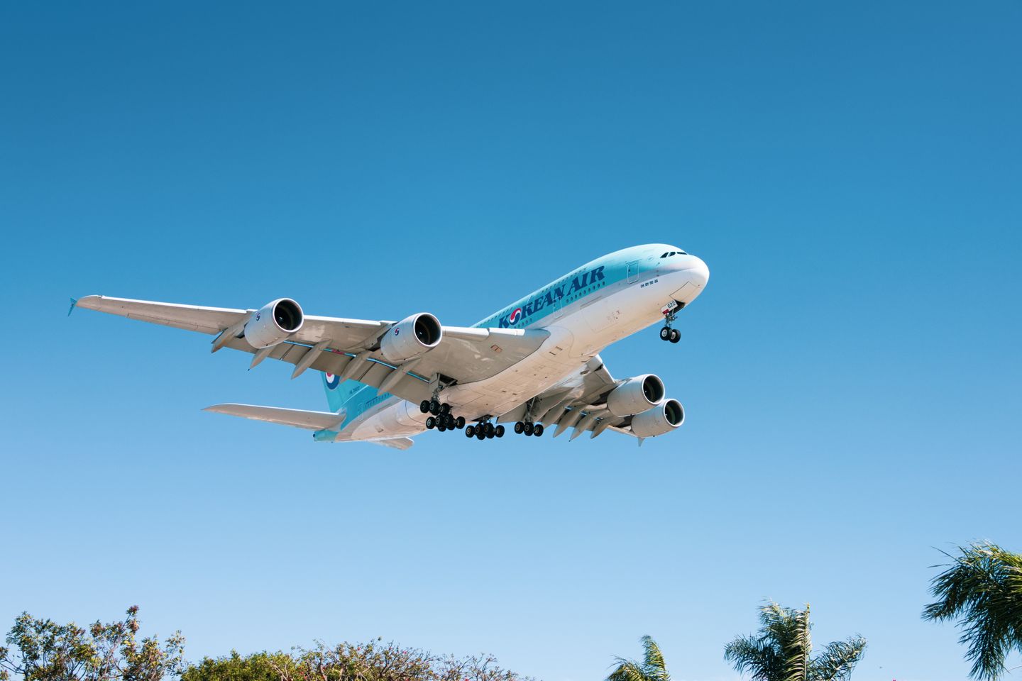 Commercial aircraft in flight against clear blue sky