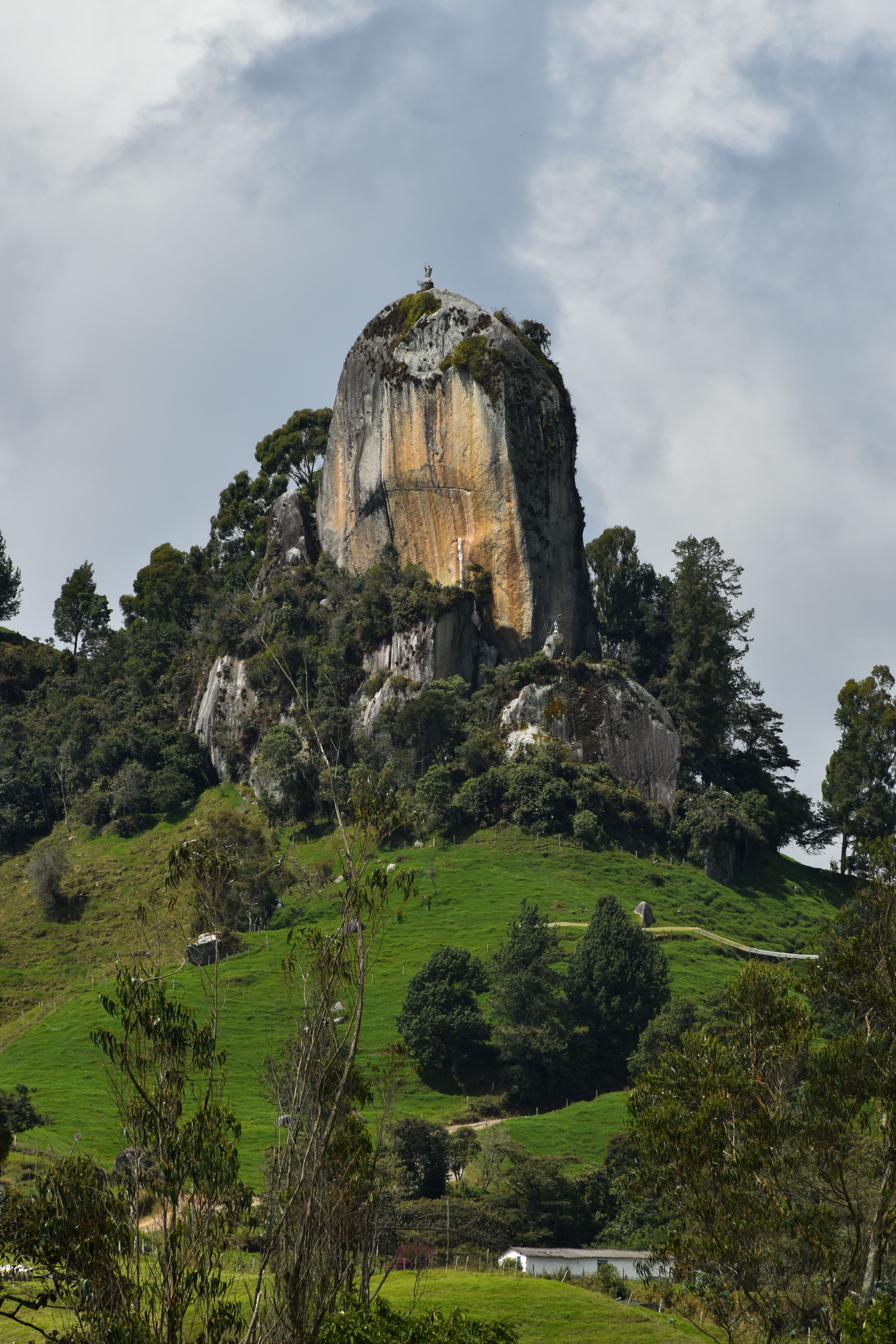 Explore the stunning natural monolith in Entrerríos, Antioquia, surrounded by lush greenery.